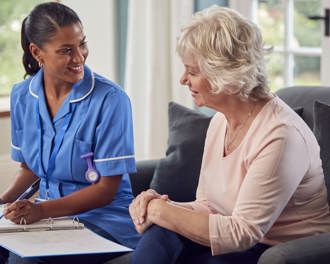Senior woman talking to nurse