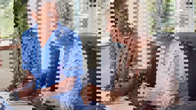 Senior woman talking to nurse