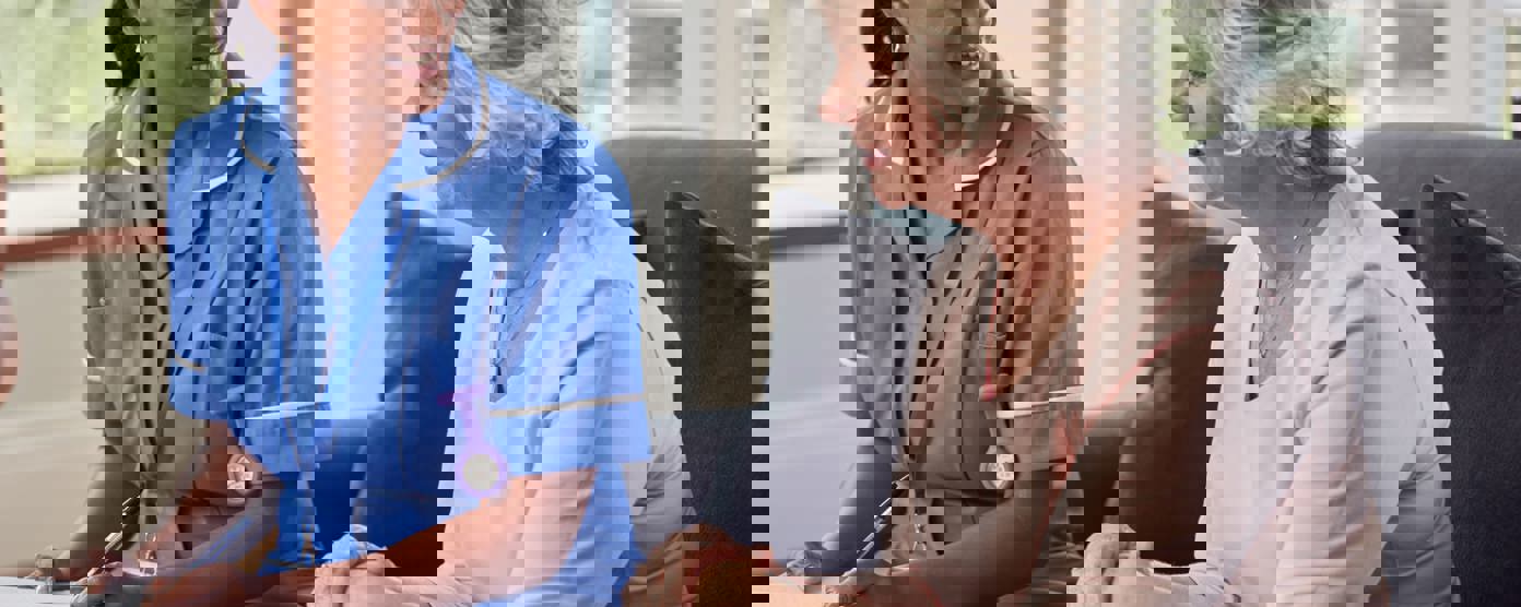 Senior woman talking to nurse