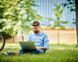 man using his laptop in a park