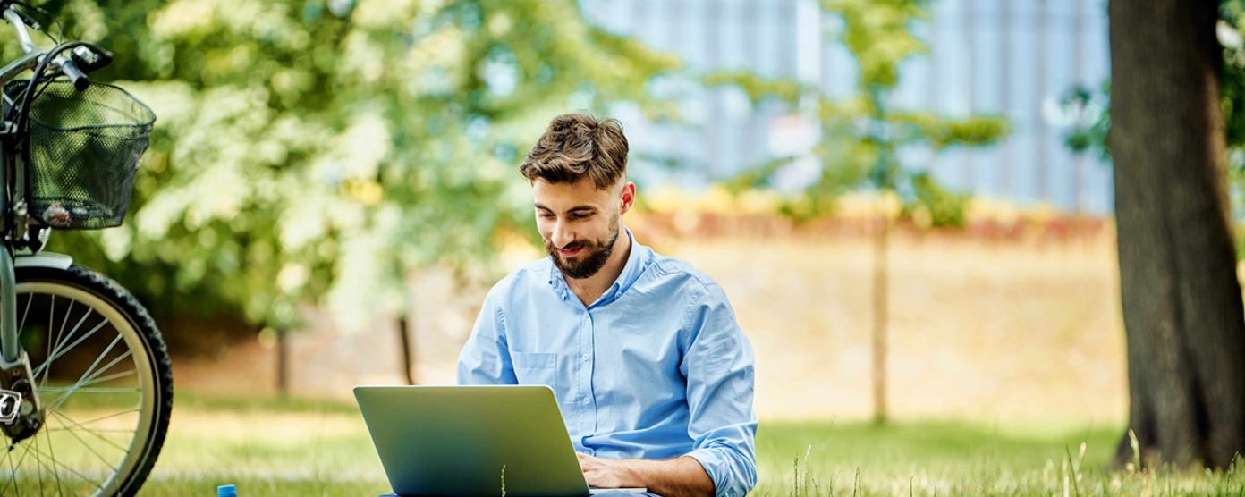 man using his laptop in a park