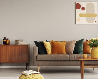 Modern living room with a neutral-toned sofa, colorful throw pillows.