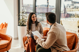 Relaxed meeting between two people that are smiling. meeting taking place on the sofas