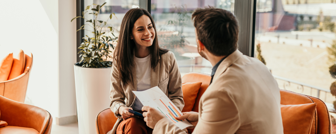 Relaxed meeting between two people that are smiling. meeting taking place on the sofas