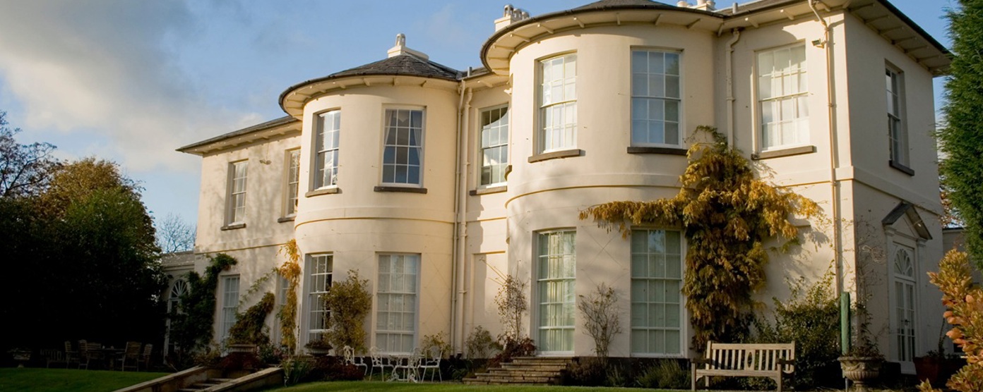 External view of large house with gardens