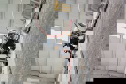 Climber at top of climbing wall