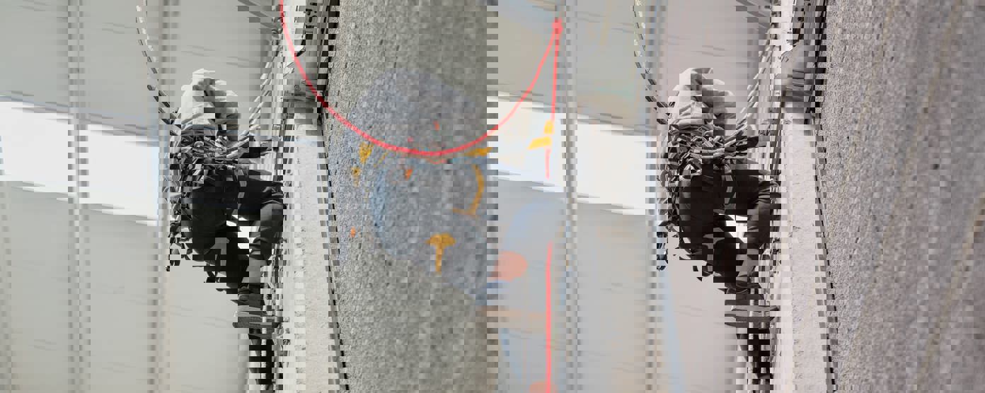 Climber at top of climbing wall