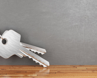 Silver keys attached to a red house-shaped keychain.