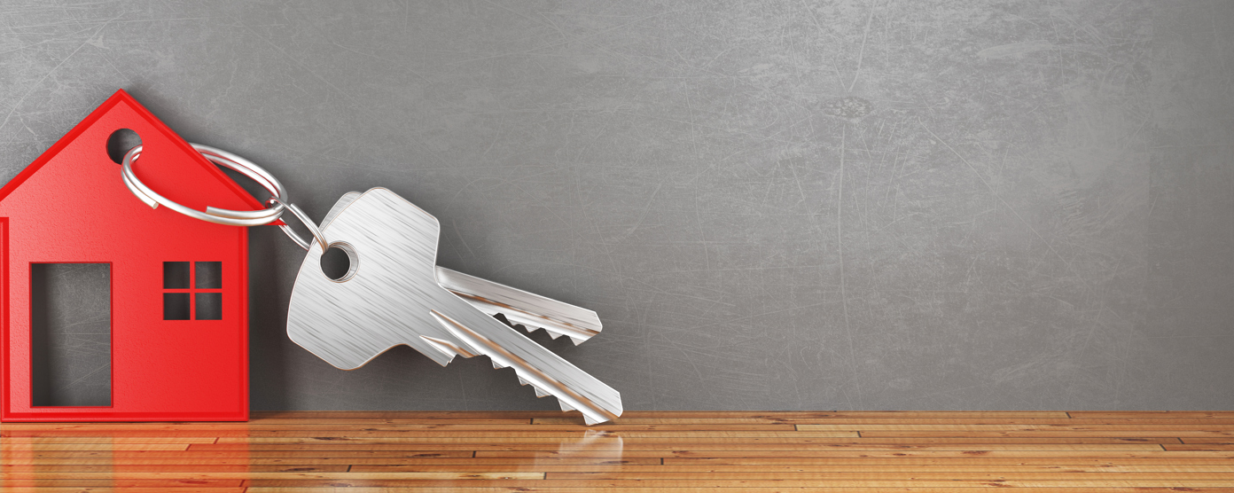Silver keys attached to a red house-shaped keychain.