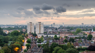 Urban homes standing tall under a stormy sky.