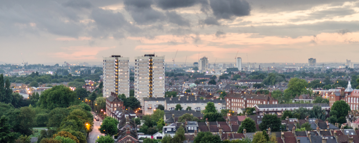 Urban homes standing tall under a stormy sky.