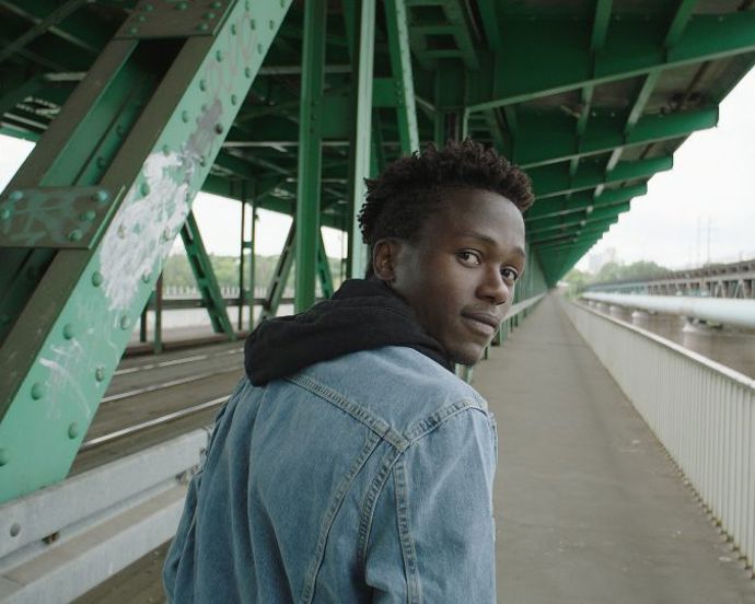 Man-walking-looking-back-at-the-camera