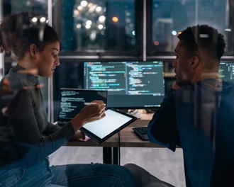 colleagues looking at a monitor in an office