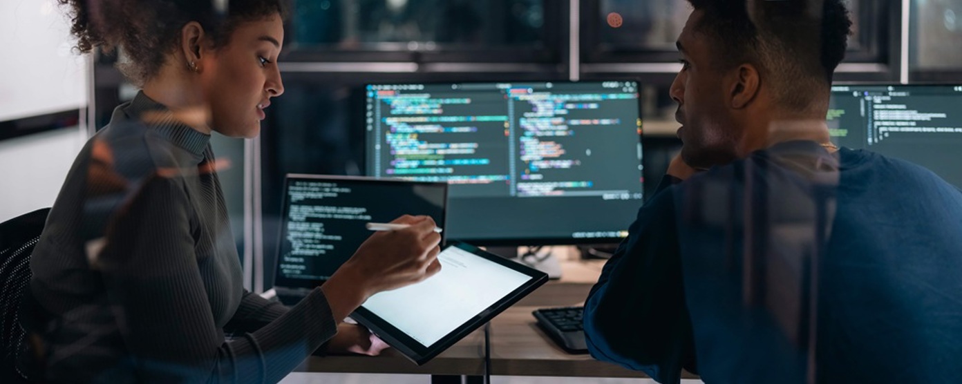 colleagues looking at a monitor in an office
