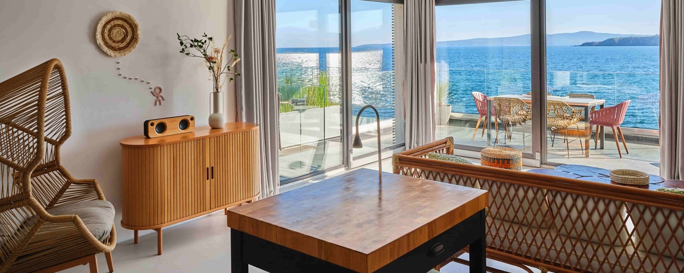 A bright living space with french windows and a beautiful sea view