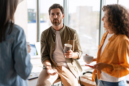 Meeting between three adults over a cup of tea - one man and two women