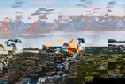 Couple hiking norway crossing river