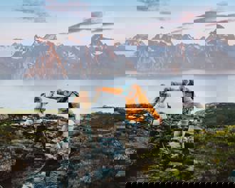 Couple hiking norway crossing river