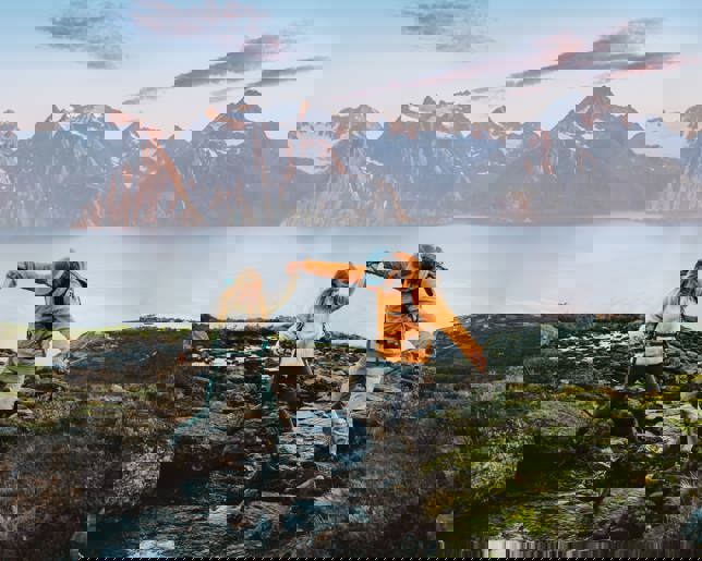 Couple hiking norway crossing river