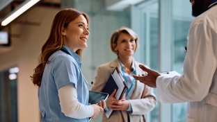 A group of doctors chatting in a corridor