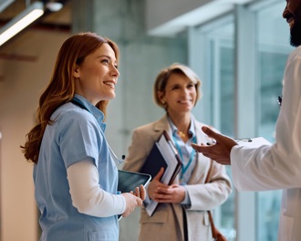 A group of doctors chatting in a corridor