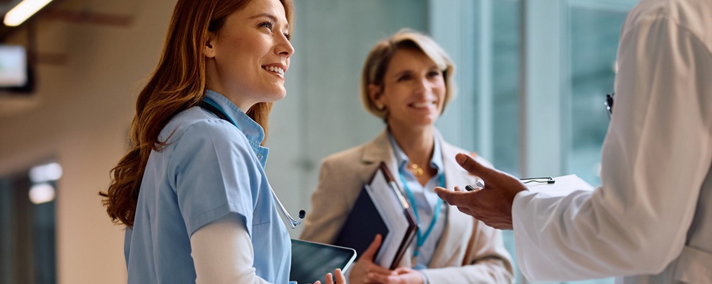 A group of doctors chatting in a corridor