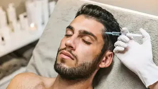calm-man-eyes-closed-having-a-botox-injection-to-temple.webp