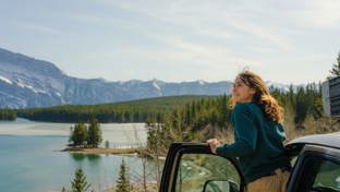 Woman looking at lake banff road trip
