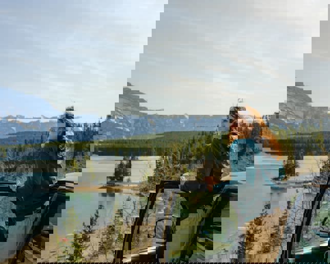 Woman looking at lake banff road trip