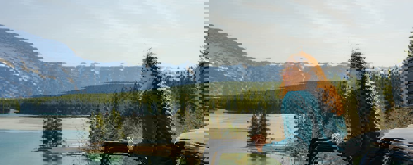 Woman looking at lake banff road trip