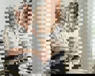 Caregiver supporting elderly man