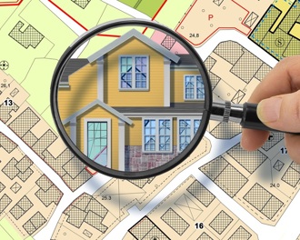 Map with a magnifying glass over a home