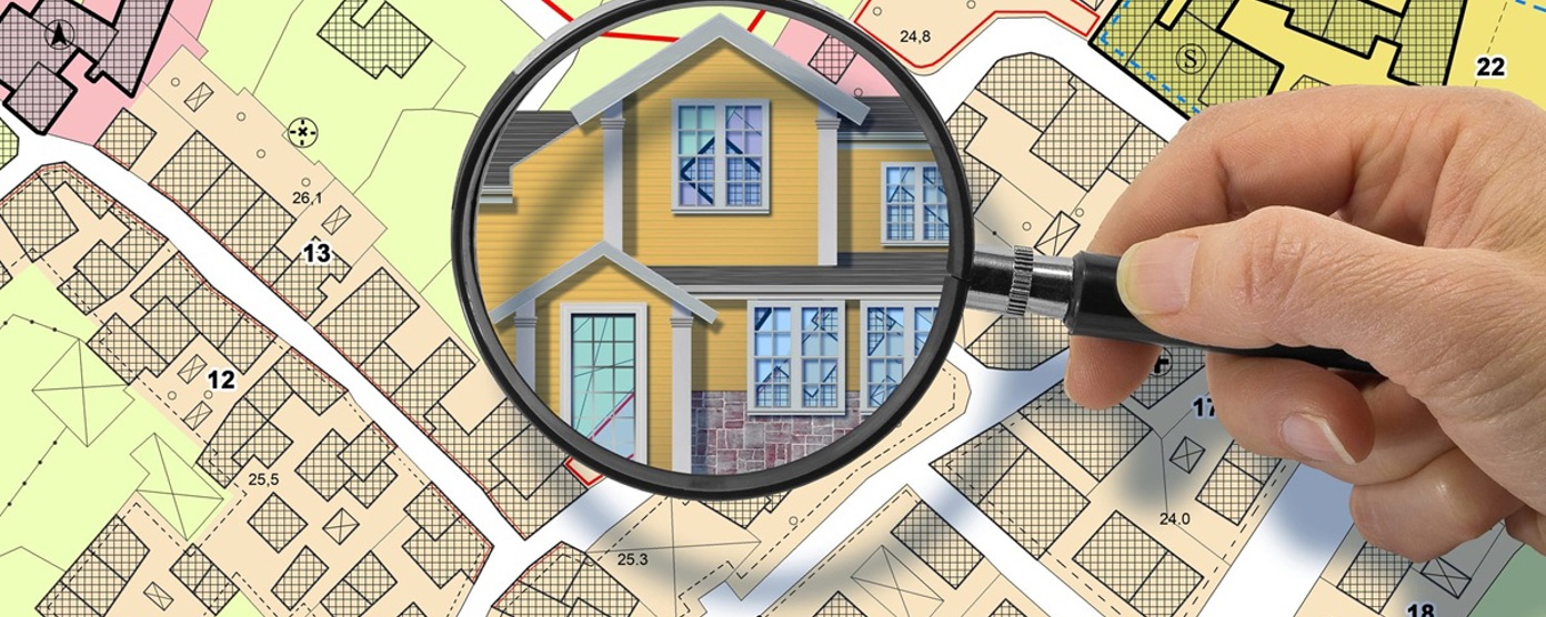 Map with a magnifying glass over a home