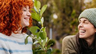Two woman laughing in nature