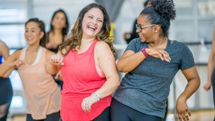 Women laughing at a keep fit class