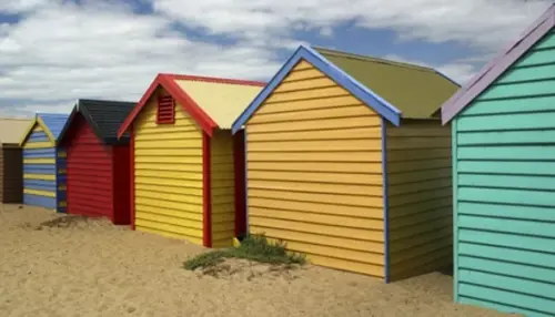 Multi colored huts on sandy ground