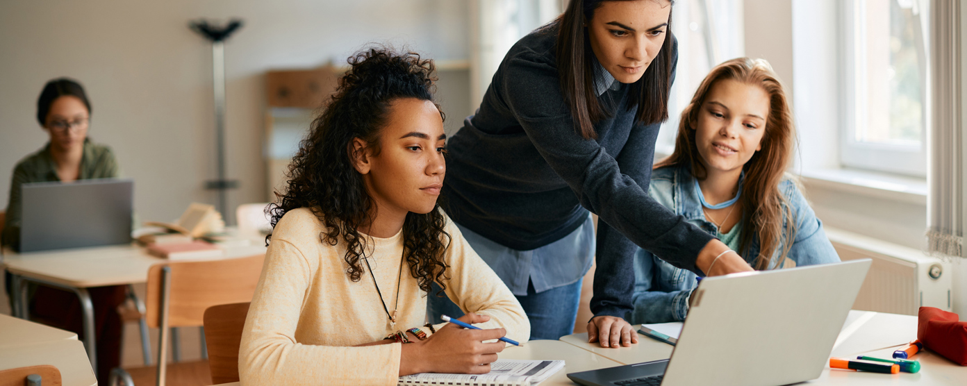  assisting with a laptop during a collaborative activity