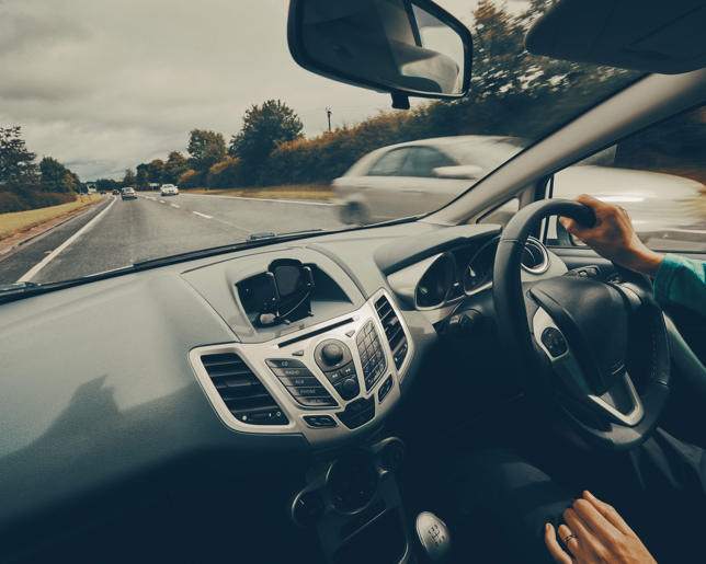 Female soldier driving military car