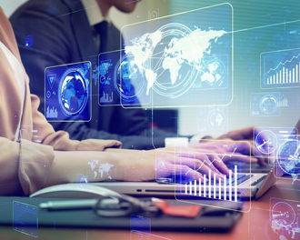 Two business professionals are working on laptops side by side, with various transparent digital data graphics.