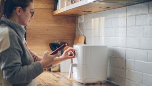 Lady using an air fryer