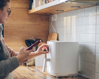 Lady using an air fryer