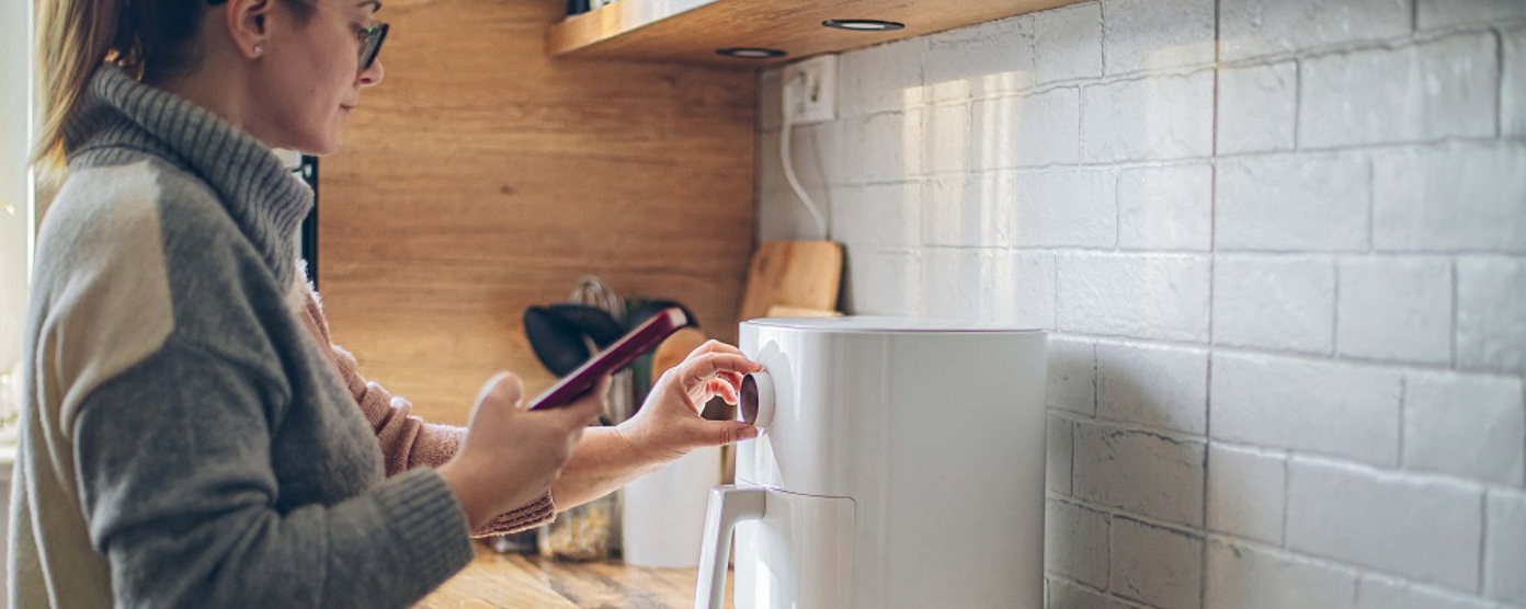 Lady using an air fryer