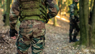 Army man walking in forest