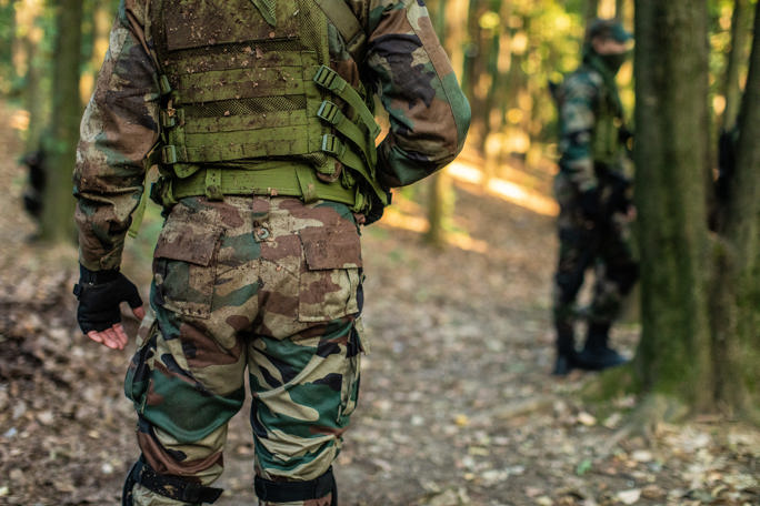 Army man walking in forest