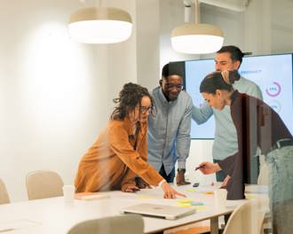 Professionals are working together in a modern office, analyzing data and planning a new strategy