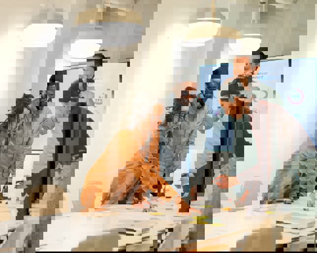 Professionals are working together in a modern office, analyzing data and planning a new strategy