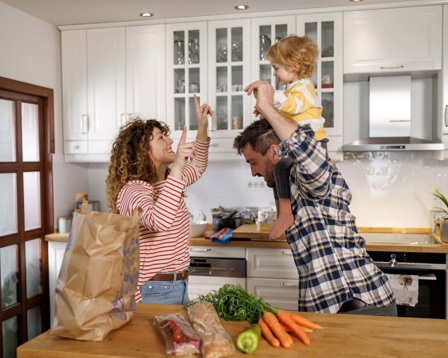 family in the kitchen smiling together