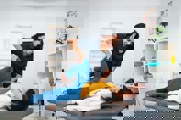 Physiotherapist assisting patient