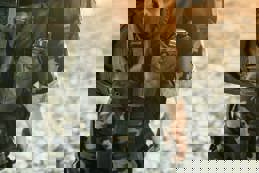 Soldier in military kit performing tasks