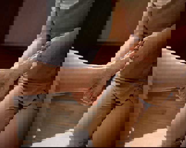 Close up of beautician during foot peeling treatment at the spa.